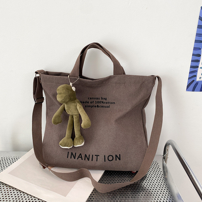 男性と女性のクロスボディバッグ 洗ったキャンバス 厚いハンドバッグ 大容量 トレンド URBAN ART 学生バッグ